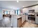 Modern kitchen with stainless steel appliances, granite countertops, and a view to the living room at 108 Oak Grove St, Kannapolis, NC 28081