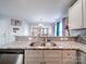 Granite counters and stainless-steel dishwasher surround a double stainless-steel sink in this kitchen view at 108 Oak Grove St, Kannapolis, NC 28081