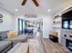 Open-concept living room with hardwood floors that lead to a dining area and kitchen at 108 Oak Grove St, Kannapolis, NC 28081