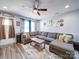 Open-concept living room featuring a sectional sofa, wood floors, and ample natural light at 108 Oak Grove St, Kannapolis, NC 28081