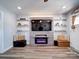 Modern living room features decorative shelves, a contemporary fireplace, and comfortable seating at 108 Oak Grove St, Kannapolis, NC 28081