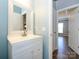 Bathroom featuring a single vanity sink with bright white cabinets and tile flooring at 10826 Saltmarsh Ln, Charlotte, NC 28278