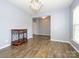 Bright living room featuring wood-look floors, chandelier, and an inviting atmosphere at 10826 Saltmarsh Ln, Charlotte, NC 28278