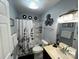 Well-lit bathroom with a shower-tub combo and a vanity with granite countertop and framed mirror at 109 Stroupe Rd # E, Gastonia, NC 28056