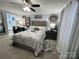 Beautiful bedroom with a tufted headboard, floral bedding, and an ensuite bathroom for added convenience at 109 Stroupe Rd # E, Gastonia, NC 28056