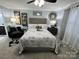 Cozy bedroom with a decorative headboard, stylish lamps, and comfortable seating area at 109 Stroupe Rd # E, Gastonia, NC 28056