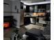 Modern kitchen with stainless steel appliances, dark cabinetry, and cozy fireplace creating an inviting atmosphere at 109 Stroupe Rd # E, Gastonia, NC 28056