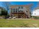 Expansive backyard featuring a two-story deck, patio, and lush lawn, ideal for outdoor living and entertaining at 11001 Valley Spring Dr, Charlotte, NC 28277