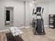 Basement exercise area with modern fitness equipment, a sleek mirror, and stylish decor at 11001 Valley Spring Dr, Charlotte, NC 28277