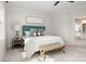 Bedroom featuring a comfortable bed with a tufted headboard and an ensuite bathroom at 11001 Valley Spring Dr, Charlotte, NC 28277