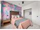 Bedroom featuring carpet floors, a decorative accent wall, and natural light from windows at 11001 Valley Spring Dr, Charlotte, NC 28277