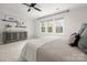 Comfortable bedroom featuring a warm-toned comforter, hardwood floors, and natural light at 11001 Valley Spring Dr, Charlotte, NC 28277