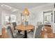 Cozy dining area with a woven pendant light and views of the living room and office at 11001 Valley Spring Dr, Charlotte, NC 28277