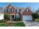 Traditional brick home with well-maintained landscaping and a two-car garage at 11001 Valley Spring Dr, Charlotte, NC 28277
