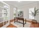 Comfortable office space featuring large windows, decorative shelving, and a stylish rug at 11001 Valley Spring Dr, Charlotte, NC 28277