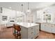 Bright kitchen with large island, stainless steel appliances, and hardwood floors at 11001 Valley Spring Dr, Charlotte, NC 28277