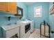 Functional laundry room with modern appliances, utility sink, and well lit at 11001 Valley Spring Dr, Charlotte, NC 28277