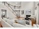 Spacious living room with a fireplace, large sofa, staircase, and built-in shelves at 11001 Valley Spring Dr, Charlotte, NC 28277