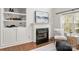 Inviting living room with a cozy fireplace, built-in shelves, and a comfortable armchair at 11001 Valley Spring Dr, Charlotte, NC 28277