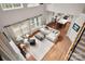 Open-concept living room with hardwood floors and large windows with natural light at 11001 Valley Spring Dr, Charlotte, NC 28277