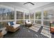 Bright sunroom featuring comfortable wicker furniture and large windows offering scenic views and natural light at 11001 Valley Spring Dr, Charlotte, NC 28277