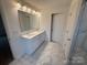 Bathroom featuring double vanity, marble tile flooring, and glass shower door at 12027 Mariners Cove Ct # 381, Lancaster, SC 29720