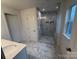 Modern bathroom featuring a glass-enclosed shower with marble tile and sleek fixtures at 12027 Mariners Cove Ct # 381, Lancaster, SC 29720