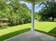 A beautiful back yard with lush green grass, a concrete patio, and shade trees at 177 Glenn Dr, Mooresville, NC 28115