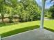 Back Yard view from the concrete patio overlooking the lush green grass and mature shade trees at 177 Glenn Dr, Mooresville, NC 28115
