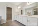 Bathroom with double sink, white cabinets, large mirror, and tile floor at 177 Glenn Dr, Mooresville, NC 28115