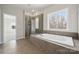 Bathroom featuring large bathtub and glass shower with large windows at 177 Glenn Dr, Mooresville, NC 28115
