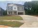 Charming two-story home with a spacious driveway and a mix of stone and gray siding at 177 Glenn Dr, Mooresville, NC 28115
