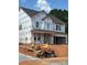 New two-story home shows Tyvek HomeWrap, windows installed, and the garage ready for doors at 177 Glenn Dr, Mooresville, NC 28115