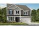 Charming two-story home featuring stone accents, gray siding and a two-car garage at 177 Glenn Dr, Mooresville, NC 28115