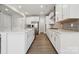 Modern kitchen with white cabinets, stainless steel appliances, and a spacious kitchen island at 177 Glenn Dr, Mooresville, NC 28115