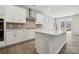 Bright kitchen showcasing white cabinetry, stainless steel appliances, and a kitchen island at 177 Glenn Dr, Mooresville, NC 28115