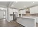 Modern kitchen with stainless steel appliances, gray backsplash, island, and white cabinetry at 177 Glenn Dr, Mooresville, NC 28115