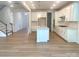 Bright kitchen with island, white cabinets, stainless appliances, hardwood flooring, and lots of natural light at 177 Glenn Dr, Mooresville, NC 28115