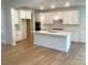 Bright, open kitchen boasts white cabinetry, a large island, and stainless steel appliances at 177 Glenn Dr, Mooresville, NC 28115