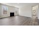 Open-concept living room featuring a fireplace, large windows, and hardwood floors at 177 Glenn Dr, Mooresville, NC 28115