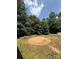 A cleared circle in the backyard surrounded by grass and mature trees at 191 Ashford Dr, Olin, NC 28660