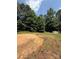 A cleared circle on a grassy lot with mature trees and a shed at 191 Ashford Dr, Olin, NC 28660
