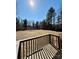 Backyard featuring a wooden deck, dry field, and forest at 191 Ashford Dr, Olin, NC 28660