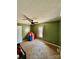 Bedroom featuring green walls, ceiling fan, and carpeted floors at 191 Ashford Dr, Olin, NC 28660