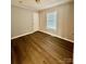 Bright bedroom with hardwood floors, white door, and a window at 191 Ashford Dr, Olin, NC 28660