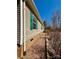 Beige home with green shutters and gravel along the side, showcasing a practical and clean design at 191 Ashford Dr, Olin, NC 28660