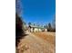 Cozy single-story home with a gravel driveway, a metal roof, and surrounded by trees at 191 Ashford Dr, Olin, NC 28660