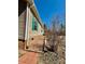 Tan home exterior with green shutters and brick foundation detail at 191 Ashford Dr, Olin, NC 28660