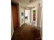 Carpeted hallway to green bedroom and vented door storage at 191 Ashford Dr, Olin, NC 28660