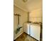 A bright laundry room with new washer, dryer, utility sink, and storage shelves at 191 Ashford Dr, Olin, NC 28660